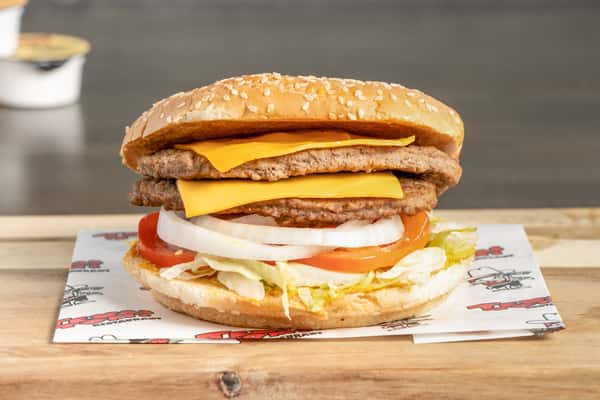 Texas Tom's double cheeseburger with two beef patties, melted cheese, onions, lettuce, and tomato on a sesame seed bun