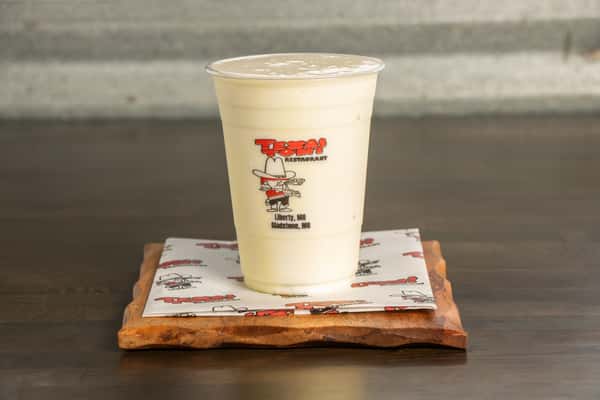 Creamy banana milkshake served fresh at Texas Tom's