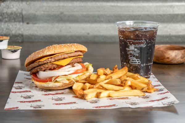 Texas Tom's double cheeseburger with two beef patties, melted cheese, onions, lettuce, and tomato on a sesame seed bun