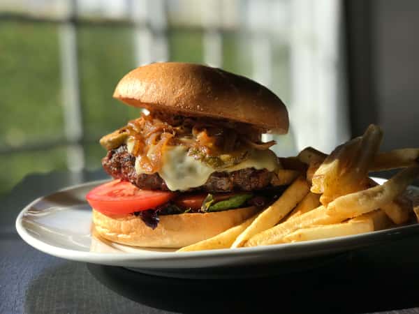 Char-Grilled White Cheddar Burger w/ Caramelized Onions, Lettuce, Tomatoes, Fried Pickles & Hand-Cut Fries