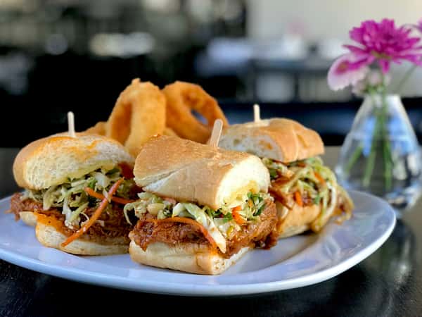 BBQ Pulled Pork Sloppy Joe w/ Smoked Gouda Cheese, Sesame Coleslaw & Housemade Onion Rings