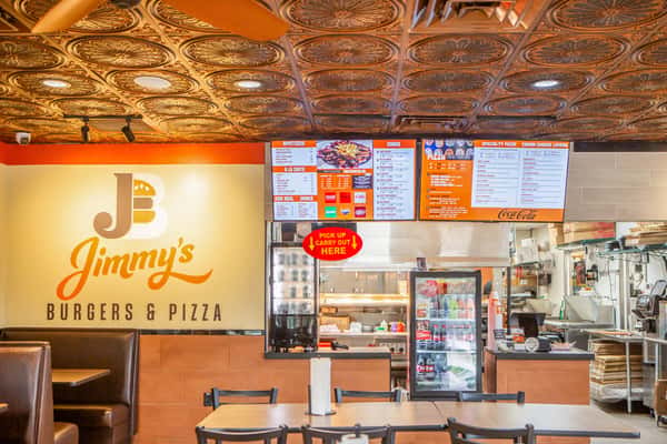 Order counter and menu boards inside Jimmy's Burgers & Pizza in Hurst, TX