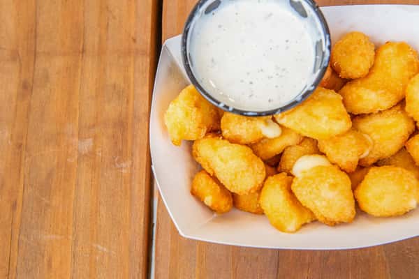 Golden fried cheese curds served with creamy dipping sauce at Jimmy's Burgers & Pizza
