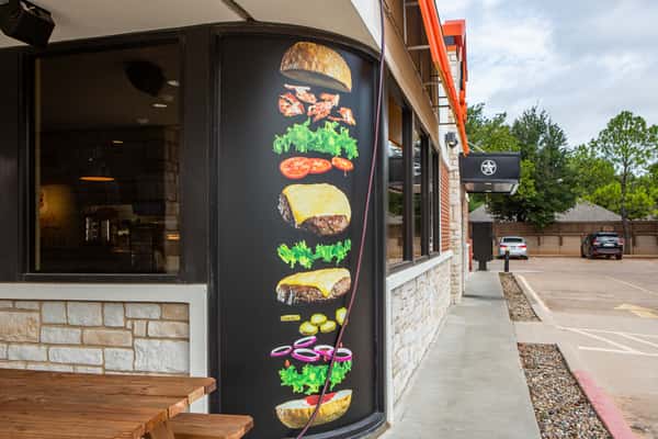 Side entrance and burger menu signage at Jimmy's Burgers & Pizza in Hurst, TX