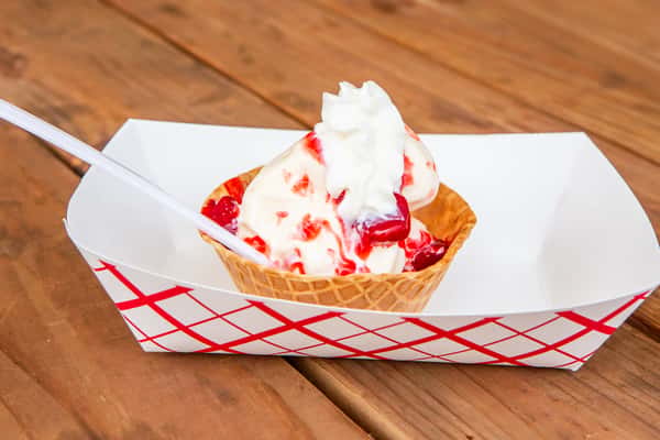 Strawberry sundae topped with whipped cream and strawberry sauce at Jimmy's Burgers & Pizza