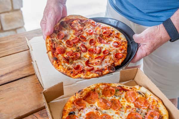 Fresh pizzas being boxed for an order at Jimmy's Burgers & Pizza in Hurst, TX