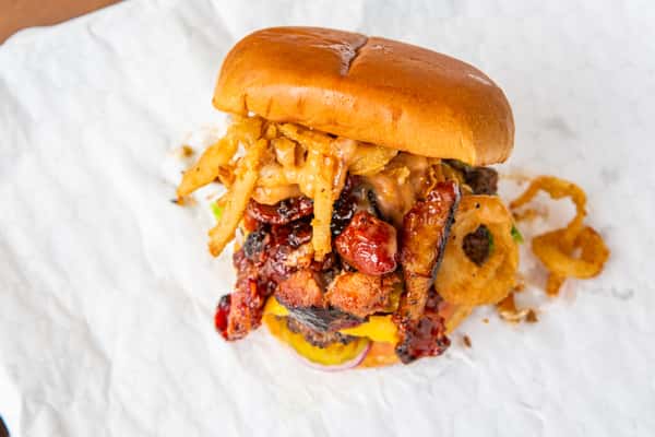 Made-to-order Cowboy burger with bacon, cheese, and crispy onions at Jimmy's Burgers & Pizza