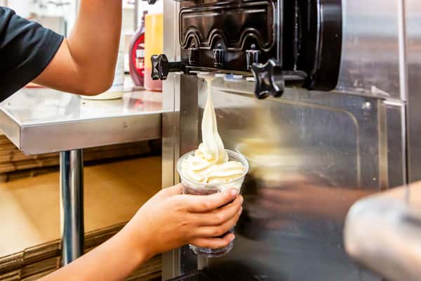 Team member preparing a soft serve dessert at Jimmy's Burgers & Pizza in Hurst, TX