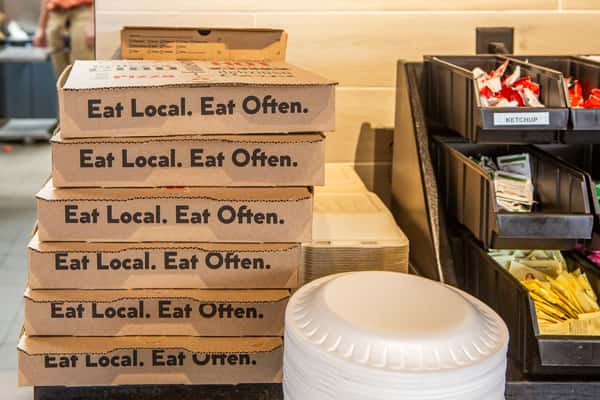 Jimmy's Burgers & Pizza takeout boxes stacked inside the Hurst, TX restaurant