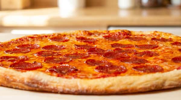 Hand-tossed brick oven pepperoni pizza with melted mozzarella and crispy crust, a classic Italian favorite at Tanino Ristorante Italiano.
