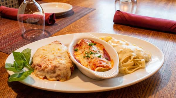 Authentic Italian lasagna layered with pasta, savory meat sauce, and melted mozzarella, baked and served with marinara at Tanino Ristorante Italiano
