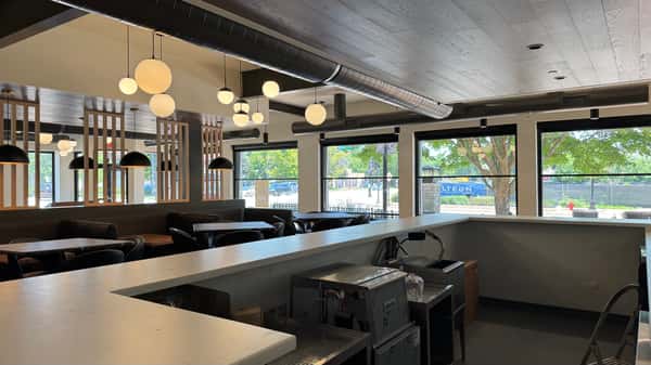 Restaurant dining area with counter seating along large windows