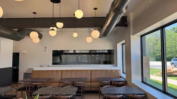 Dining area with globe pendant lights and booth seating