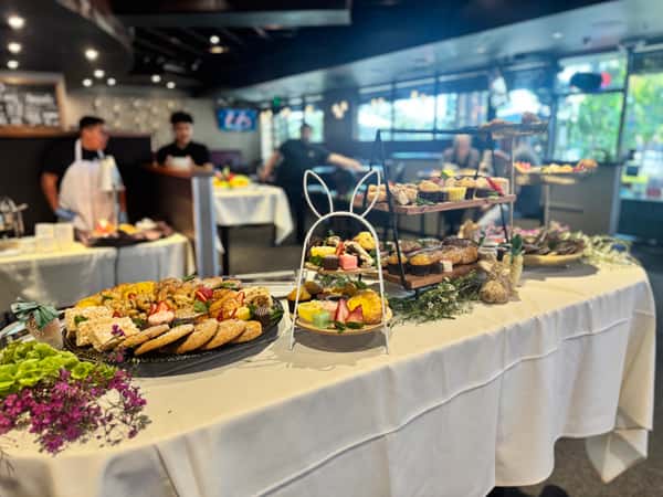 Catering event with platters of meals on a table spread