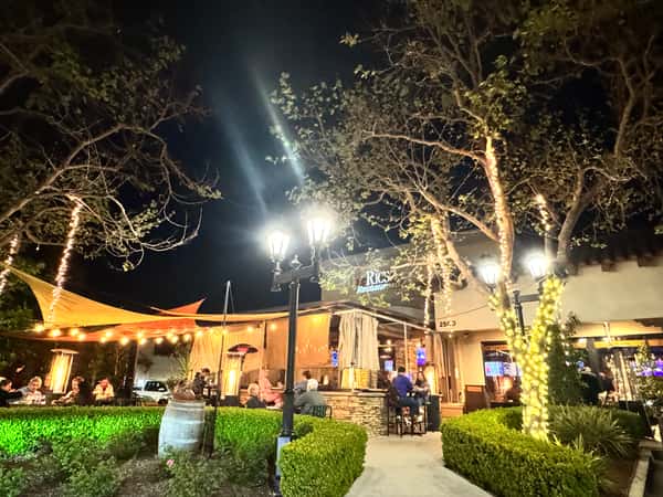 Exterior of restaurant at night with busy customers