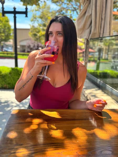 Cutsomer sipping on a drink on a sunny day