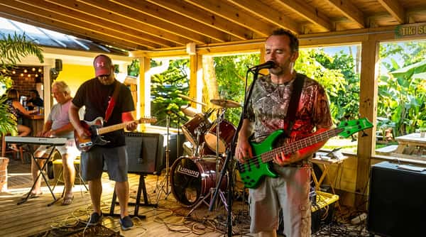 Live band performing on the covered patio at Malabar Mo's Bar & Grill in Malabar, FL with guests enjoying local music and a lively outdoor atmosphere.