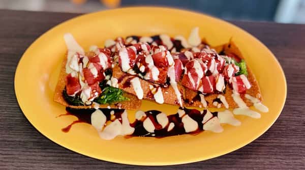 Fresh tuna poke nachos topped with crispy wontons, spicy mayo, eel sauce, and fresh garnishes at Malabar Mo's Bar & Grill in Malabar, FL.