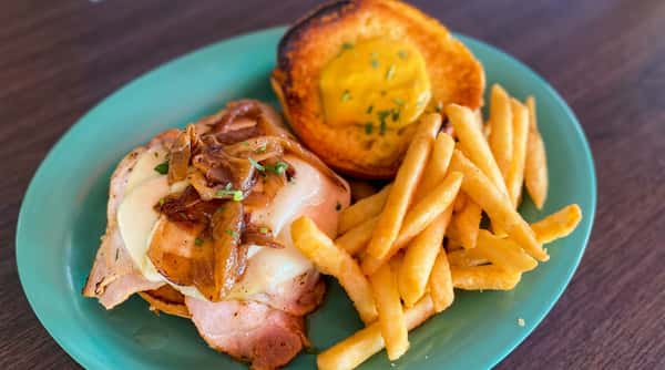 Open-faced roast beef sandwich with gravy, French fries, and a toasted side served at Malabar Mo's Bar & Grill in Malabar, FL.