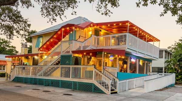 Exterior view of Malabar Mo's Bar & Grill in Malabar, FL featuring a spacious multi-level patio and welcoming coastal bar and grill atmosphere.