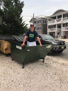 man inside dumpster