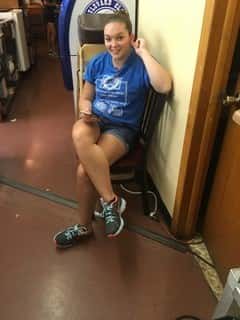 female sitting in chair smiling