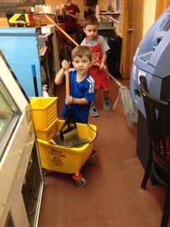 little boy mopping floor