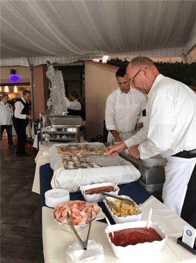 two employees preparing buffet table