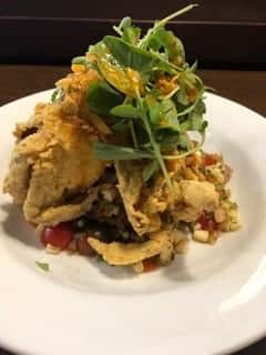 Batter dipped fried crabs atop roasted corn salsa topped with fresh watercress.