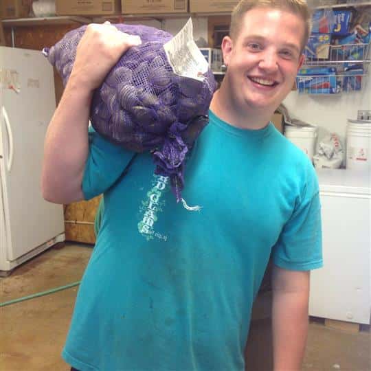 male holding sack of clams