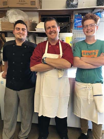 three employees posing for picture