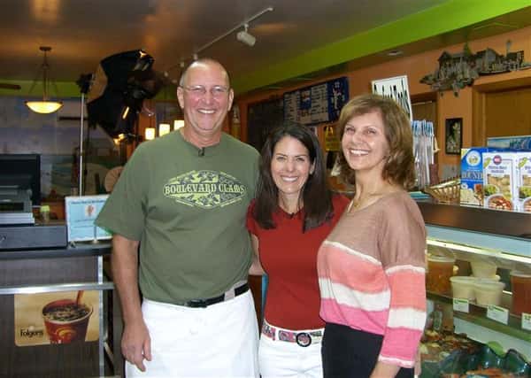 three people smiling for picture