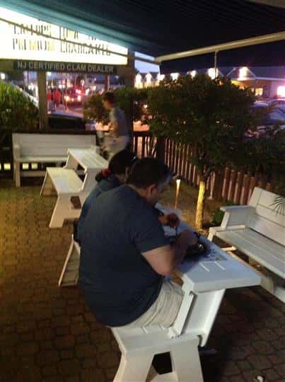 man sitting outside of restaurant