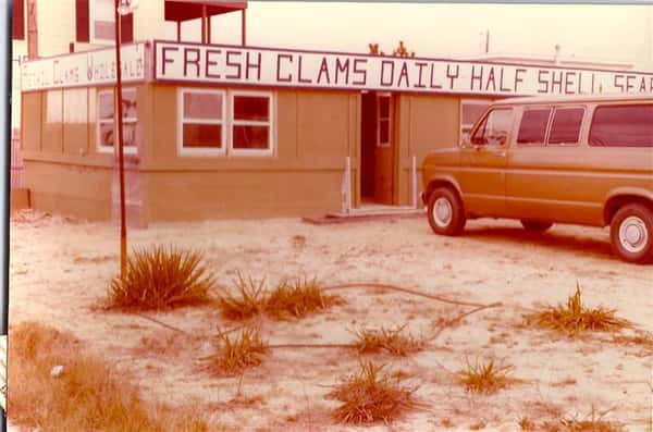 vintage photo with sign that reads fresh clams daily half