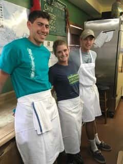 three employees smiling for picture