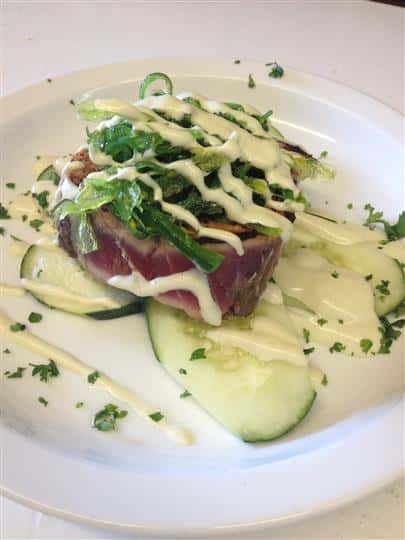raw fish over cucumbers