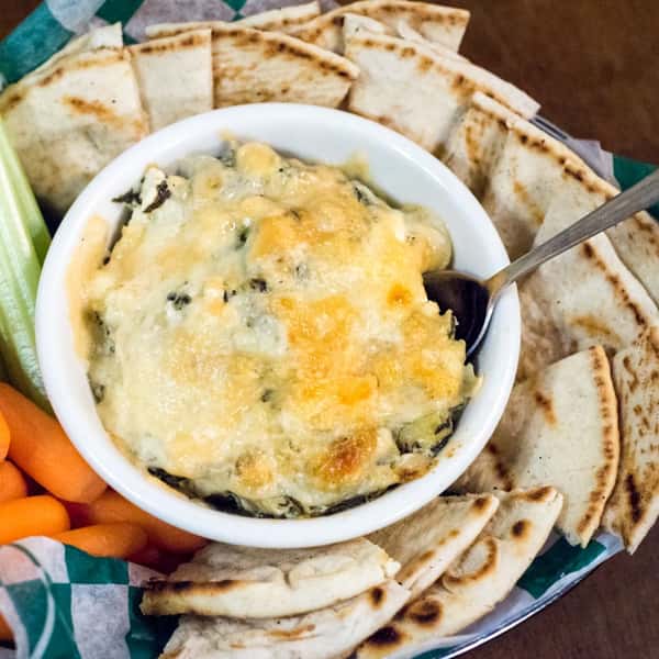 spinach dip with carrots, celery, and fresh pita