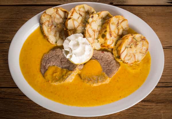 Sliced meat dish served in a sauce