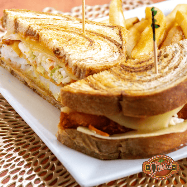 grilled sandwich with melted cheese and layers of meat served on toasted bread