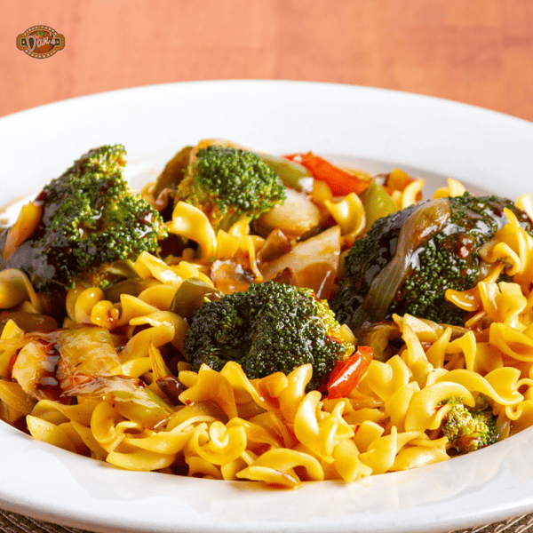 stir-fried noodles with broccoli, peppers, and savory sauce served in a white bowl