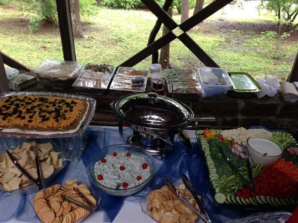 An interior buffet decorated in blue and white with several catering trays and dishes