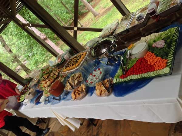 A buffet decorated in blue and white having several catering trays on it