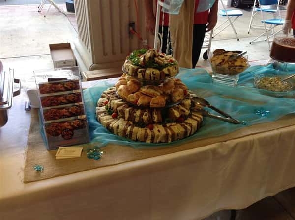 An interior buffet decorated in yellow and light blue with a sliders and sandwiches tray