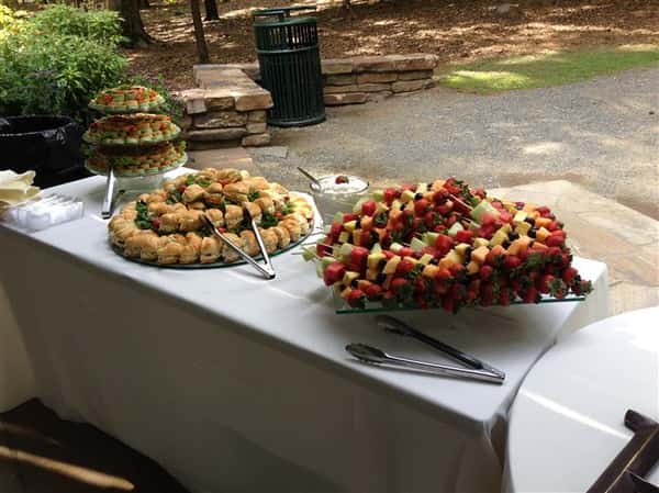 An outdoor buffet with several catering trays