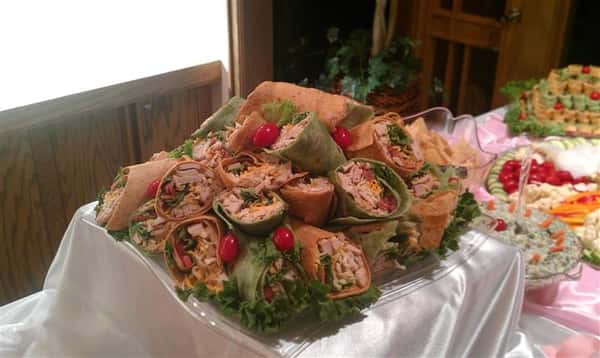 A tray of southwest chicken wraps and bacon ranch chicken wraps.
