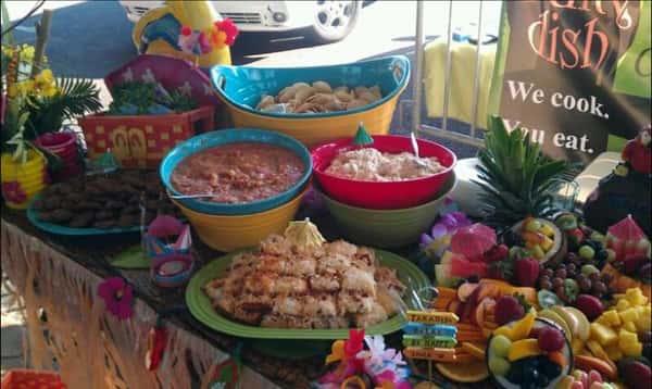 Hawaiian theme bowls and trays on a decorated buffet