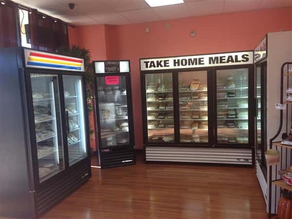 Photo of fridges with take home meals inside.