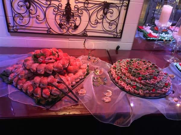 An interior buffet with a tray of mini sliders and a tray of wrap bites
