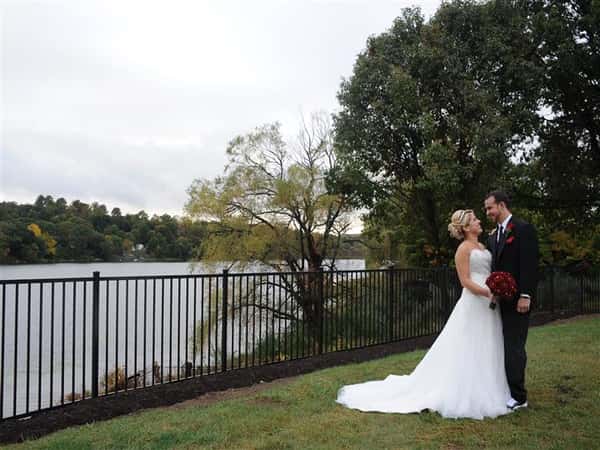 couple posing next to the lake