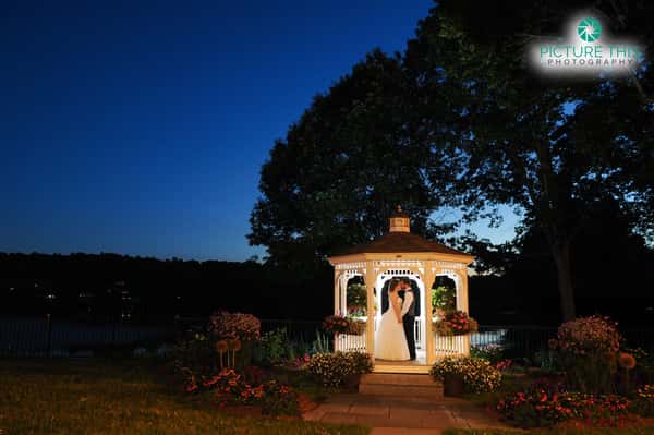 couple kissing in the outdoor gazebo at night time
